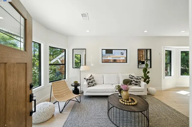 a living room with furniture and a floor to ceiling window
