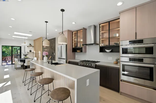 a kitchen with stainless steel appliances granite countertop a stove a sink and a refrigerator