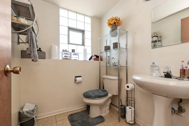a bathroom with a sink toilet and a mirror
