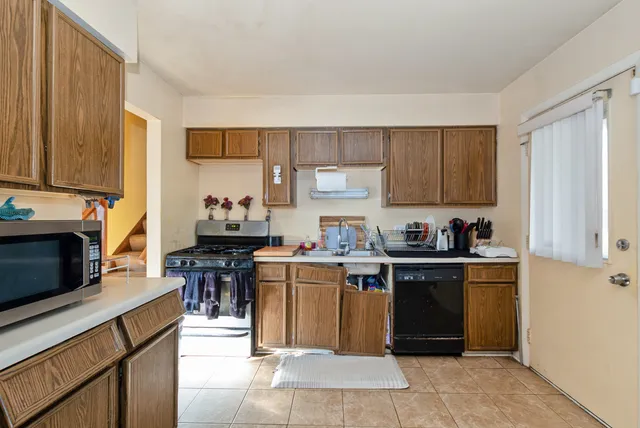a kitchen with a sink stove top oven and cabinets