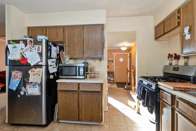 a kitchen with stainless steel appliances granite countertop a stove and a refrigerator