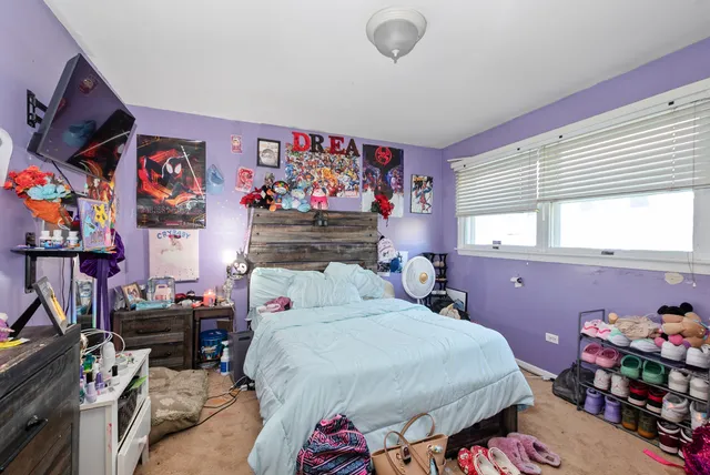 a bed room with a bed and a window