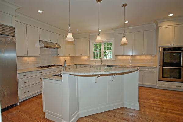 24 Elmwood Road Wellesley, MA 02481 - Photo 3 of 11 a kitchen with stainless steel appliances granite countertop a sink a stove a refrigerator and island with wooden floor