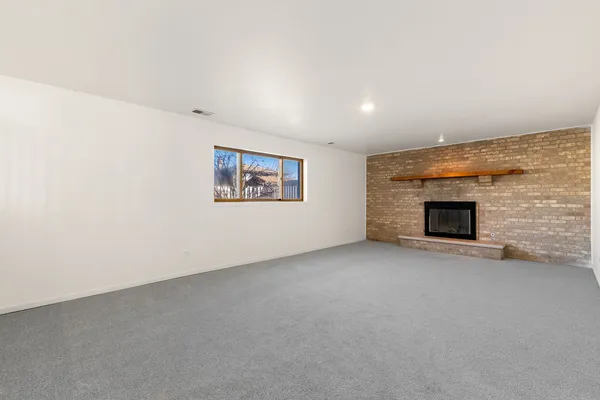 a view of empty room with fireplace
