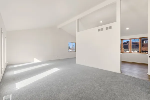 a view of a big room with closet and windows