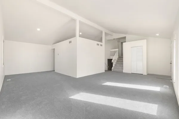 a kitchen with stainless steel appliances a stove a refrigerator and a sink with wooden floor