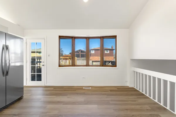 a kitchen with sink window and cabinets