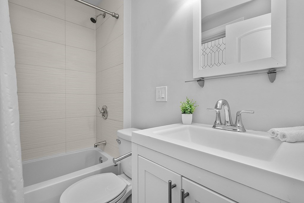 200-202 Elliot Street, Unit 1 Newton, MA 02464 - Photo 14 of 35 a bathroom with a sink toilet and shower