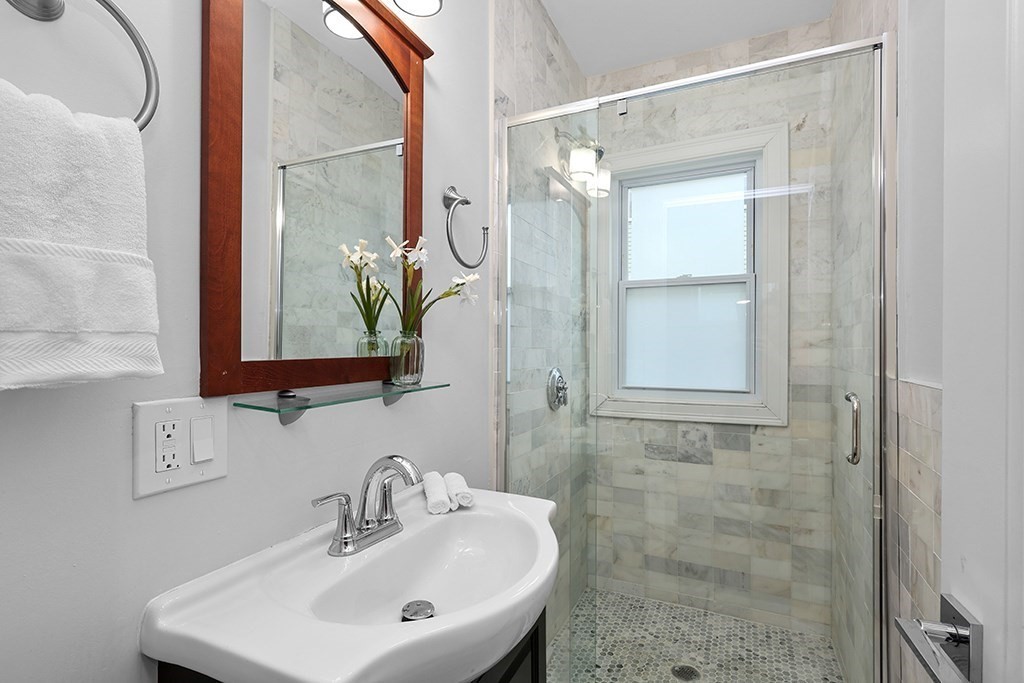 200-202 Elliot Street, Unit 1 Newton, MA 02464 - Photo 15 of 35 a bathroom with a sink and a mirror