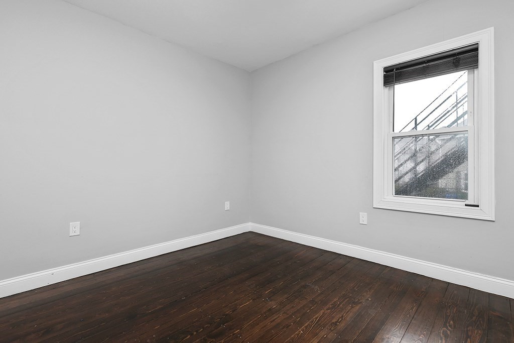 200-202 Elliot Street, Unit 1 Newton, MA 02464 - Photo 16 of 35 a view of a small space with wooden floor and a window