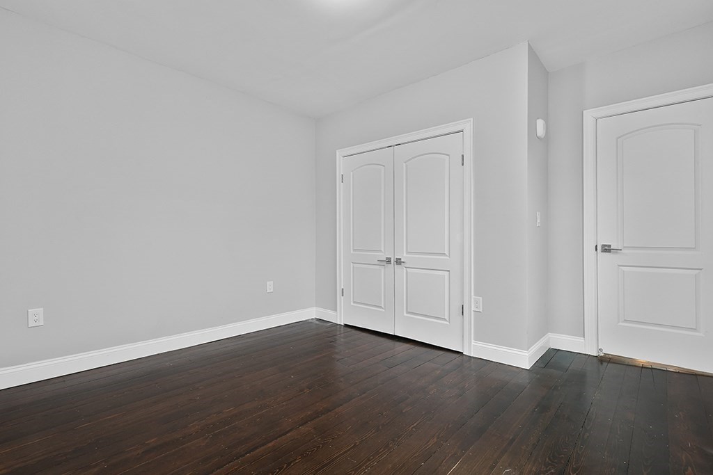 200-202 Elliot Street, Unit 1 Newton, MA 02464 - Photo 17 of 35 a view of an empty room with wooden floor