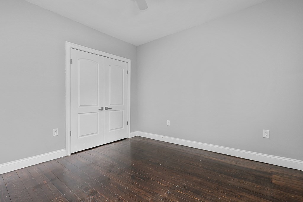 200-202 Elliot Street, Unit 1 Newton, MA 02464 - Photo 19 of 35 a view of an empty room with wooden floor