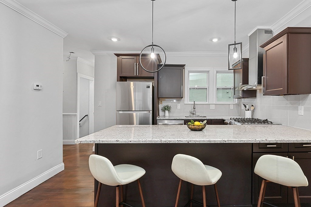 200-202 Elliot Street, Unit 1 Newton, MA 02464 - Photo 2 of 35 a kitchen with stainless steel appliances granite countertop a sink and a refrigerator
