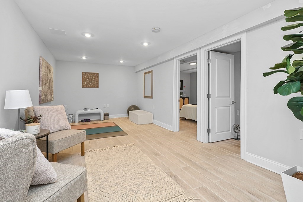 200-202 Elliot Street, Unit 1 Newton, MA 02464 - Photo 23 of 35 a bedroom with furniture and a wooden floor