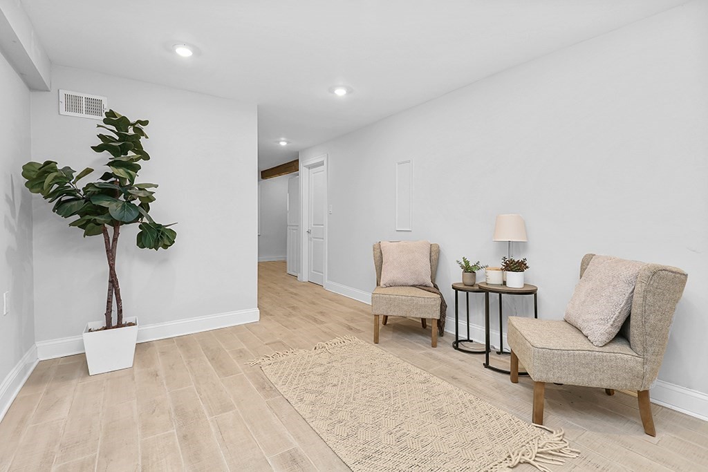 200-202 Elliot Street, Unit 1 Newton, MA 02464 - Photo 24 of 35 a living room with furniture potted plant and a table