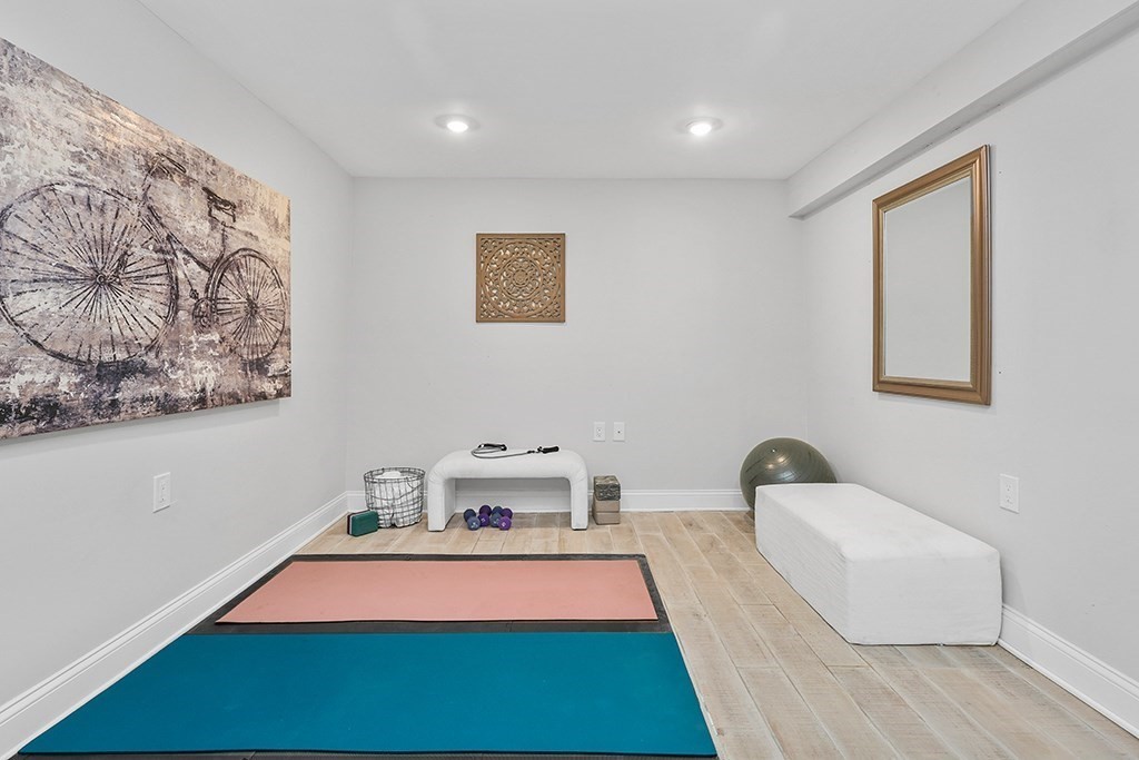 200-202 Elliot Street, Unit 1 Newton, MA 02464 - Photo 26 of 35 a bedroom with bed and a painting on the wall