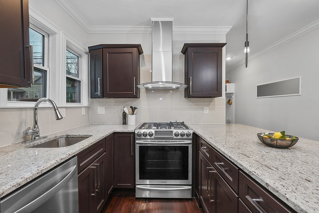 200-202 Elliot Street, Unit 1 Newton, MA 02464 - Photo 3 of 35 a kitchen with granite countertop a sink stove and cabinets