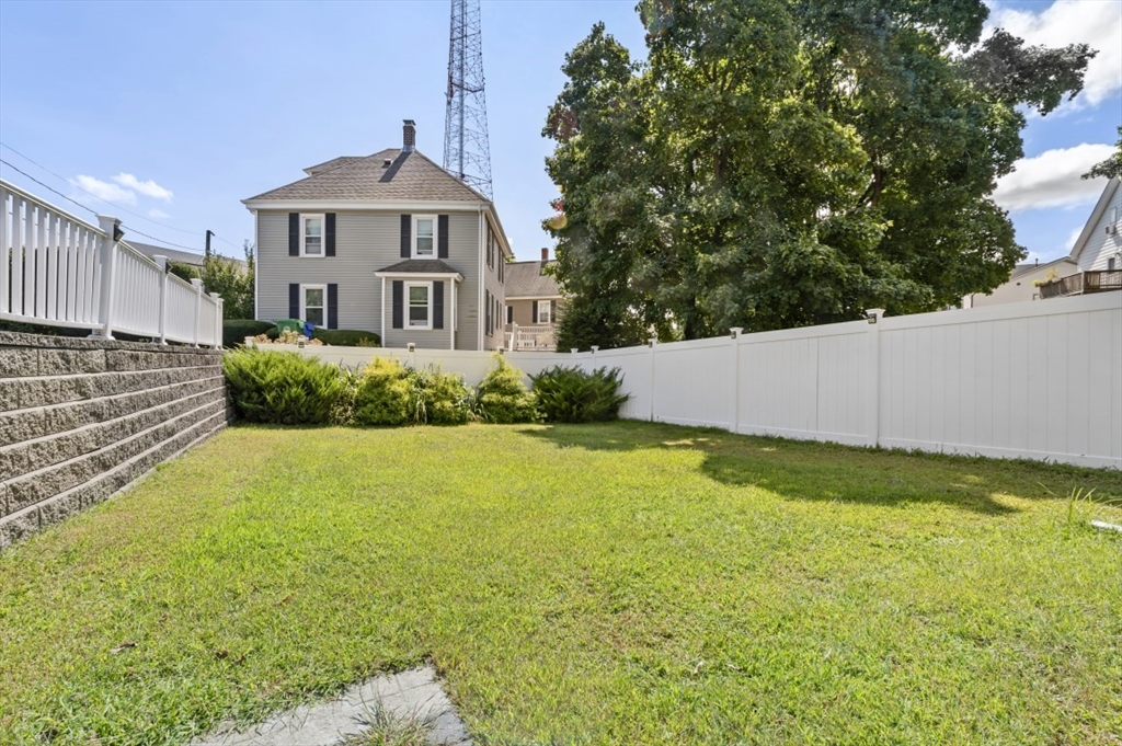 200-202 Elliot Street, Unit 1 Newton, MA 02464 - Photo 32 of 35 a front view of a house with a yard