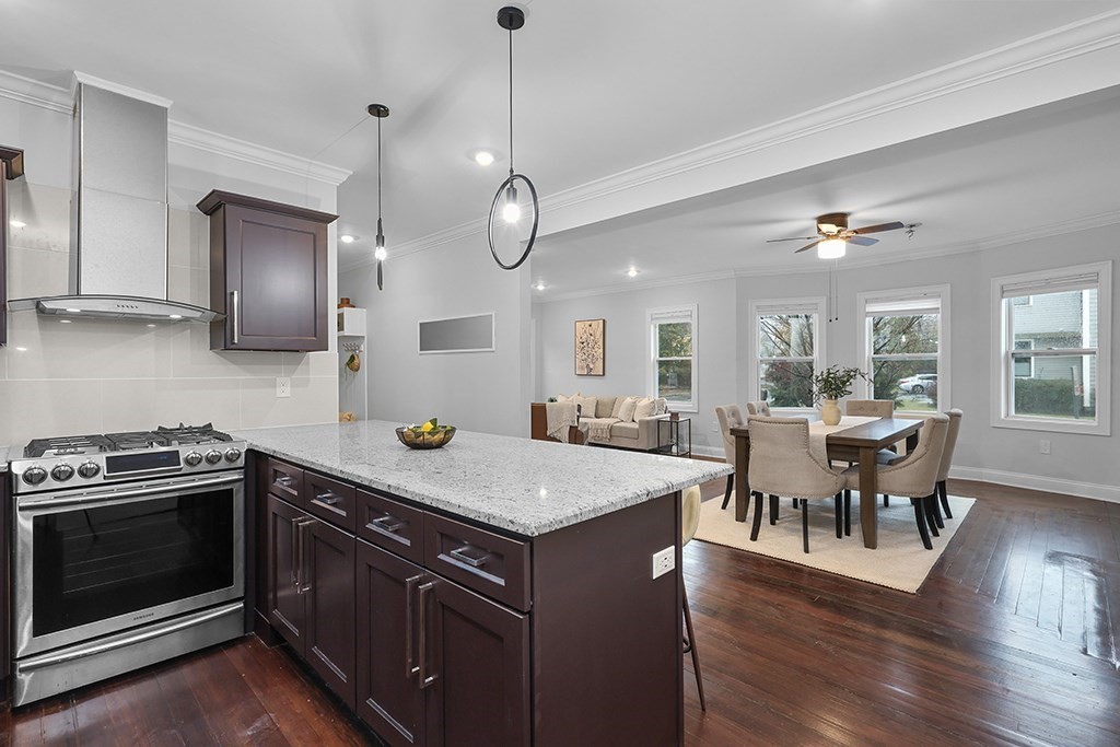 200-202 Elliot Street, Unit 1 Newton, MA 02464 - Photo 4 of 35 a kitchen with a stove kitchen island furniture and wooden floor