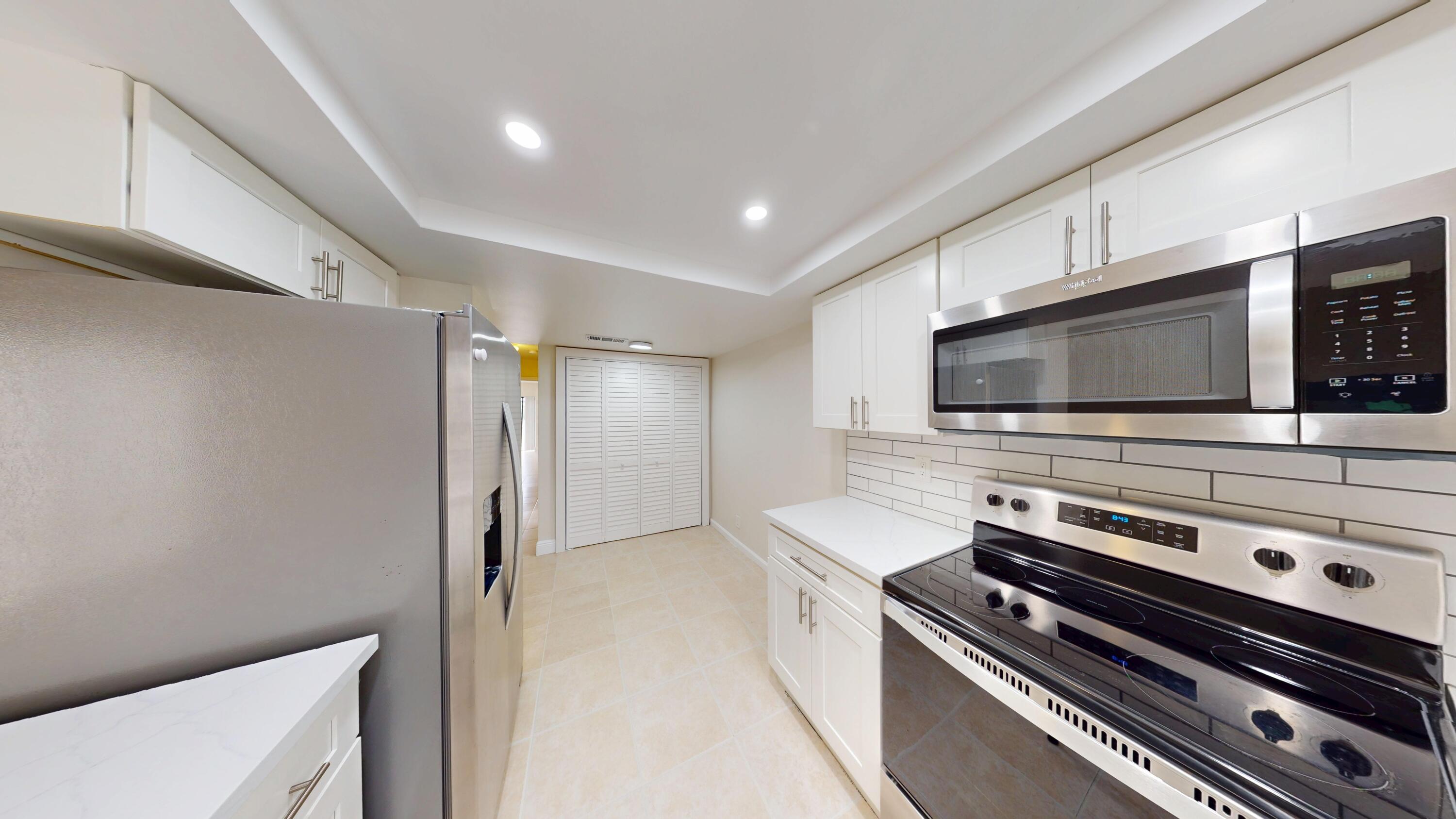 3143 Kingswood Terrace Boca Raton, FL 33431 - Photo 12 of 21 a kitchen with a stove and a microwave