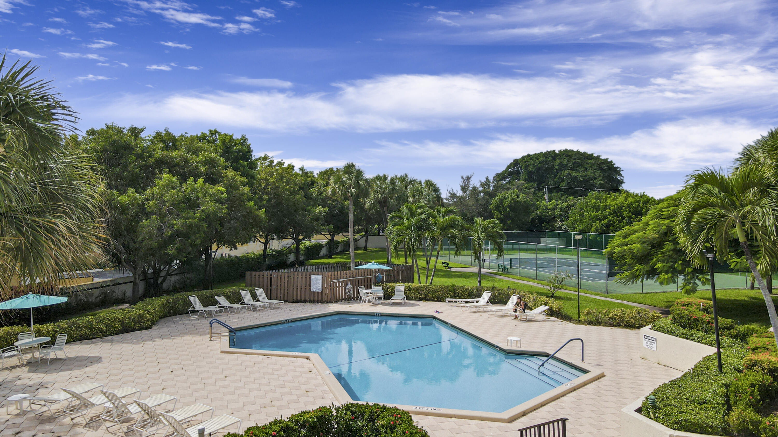3143 Kingswood Terrace Boca Raton, FL 33431 - Photo 19 of 21 a view of a swimming pool and lounge chairs in back yard of the house