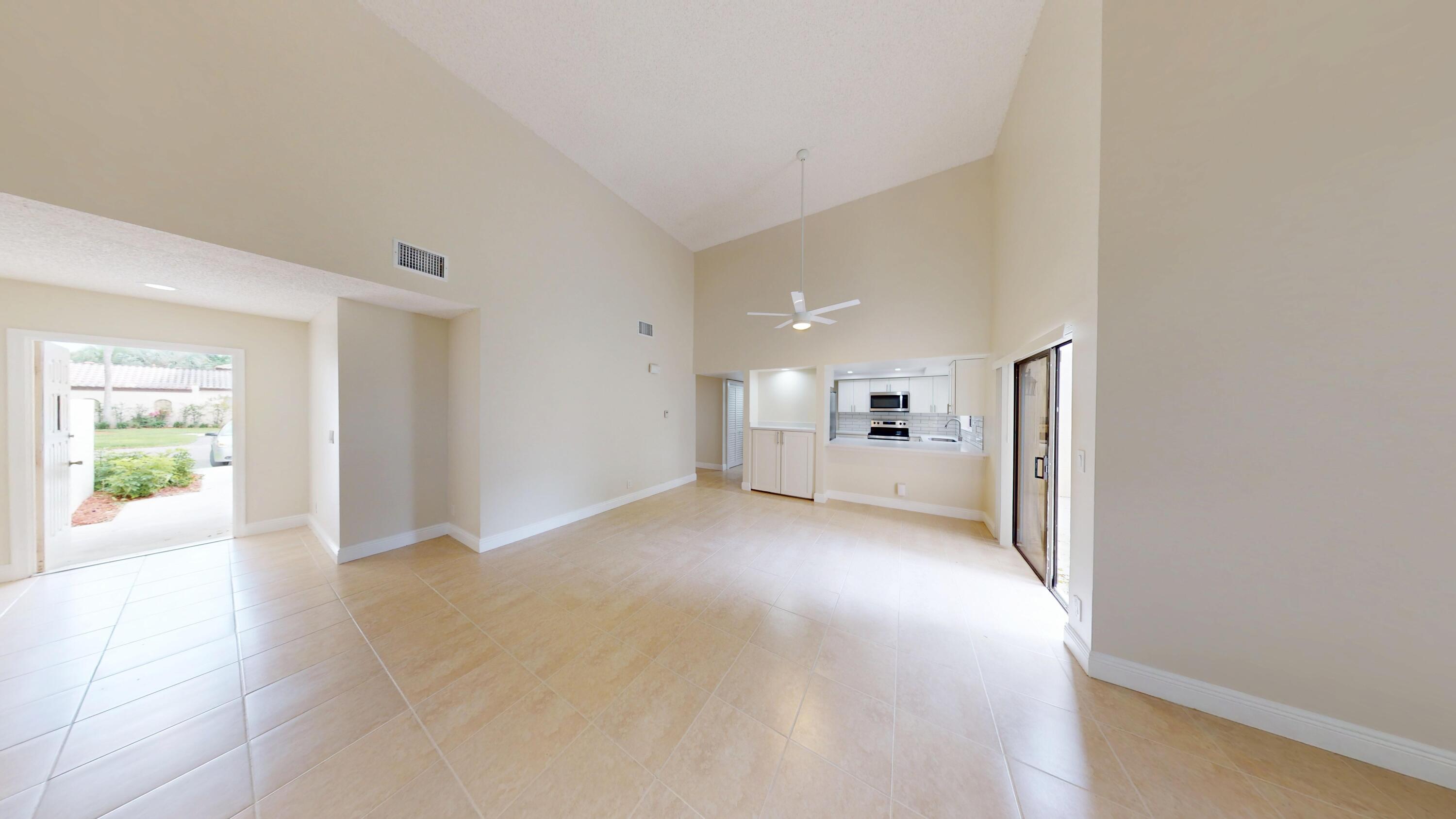 3143 Kingswood Terrace Boca Raton, FL 33431 - Photo 2 of 21 a view of a big room with windows and chandelier fan