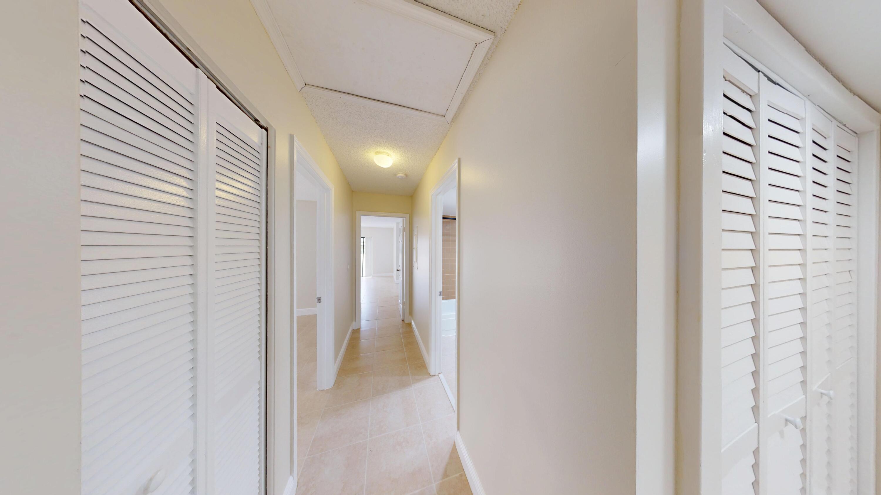 3143 Kingswood Terrace Boca Raton, FL 33431 - Photo 4 of 21 a view of a bathroom from a hallway