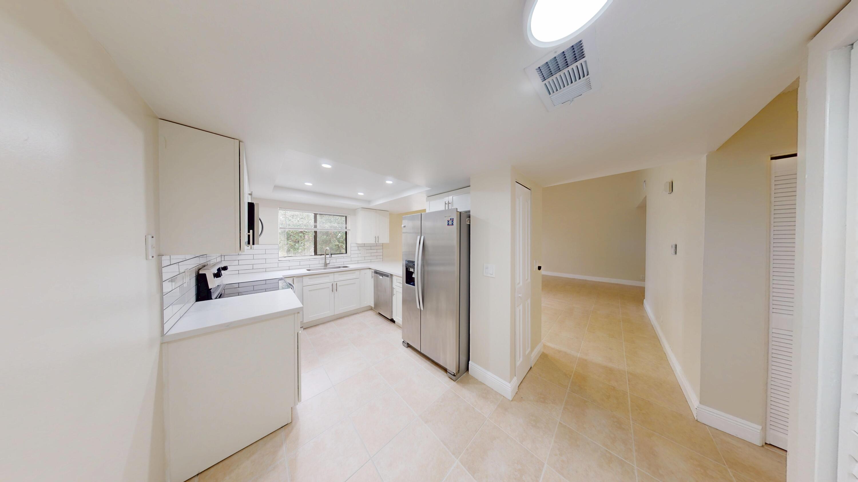 3143 Kingswood Terrace Boca Raton, FL 33431 - Photo 10 of 21 a view of a kitchen with refrigerator and windows