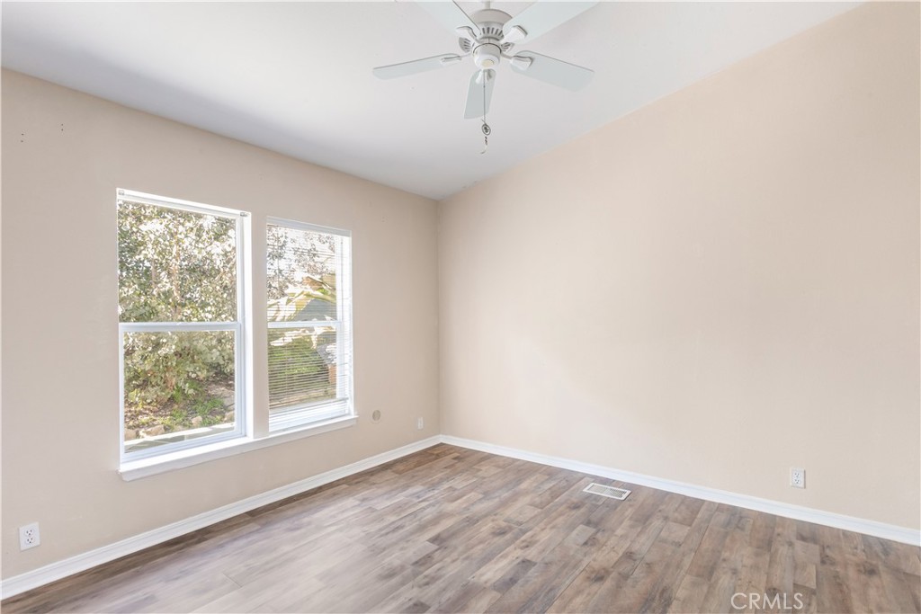 2311 Rose Road Fallbrook, CA 92028 - Photo 23 of 50 an empty room with wooden floor and windows