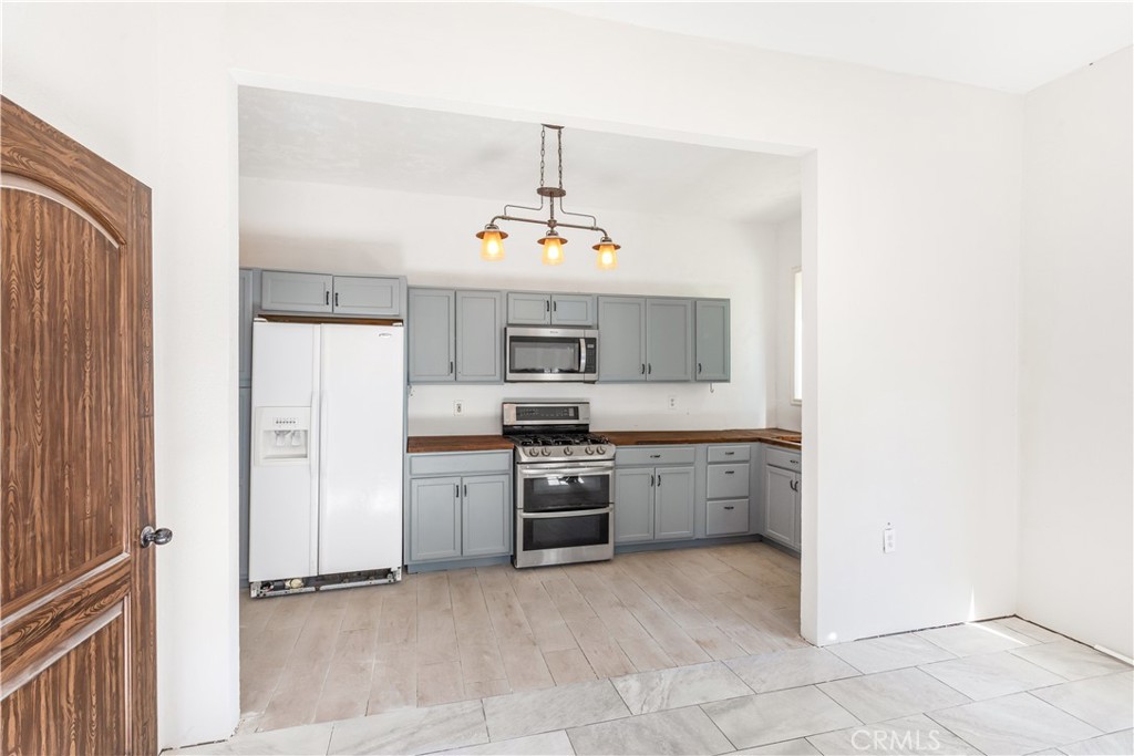 2311 Rose Road Fallbrook, CA 92028 - Photo 30 of 50 a kitchen with a stove a refrigerator and a sink