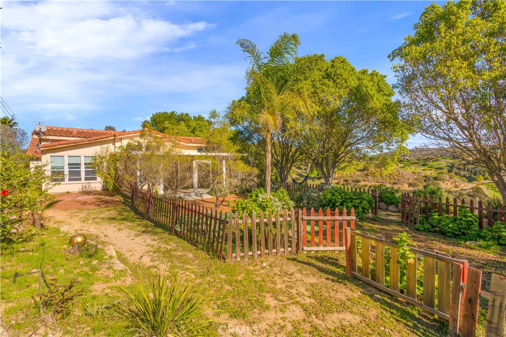2311 Rose Road Fallbrook, CA 92028 - Photo 39 of 50 a view of a wrought iron wall next to a yard