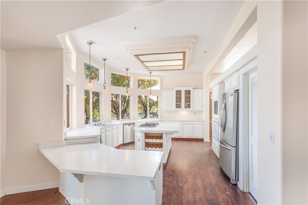 2311 Rose Road Fallbrook, CA 92028 - Photo 10 of 50 a view of a kitchen with kitchen island wooden floor and stainless steel appliances