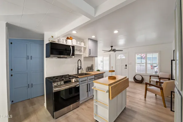 a kitchen with a stove a sink and a refrigerator