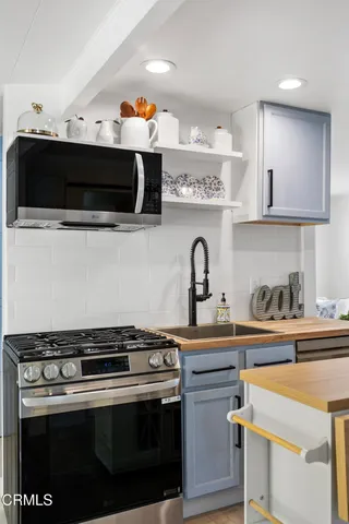 a stove top oven sitting inside of a kitchen