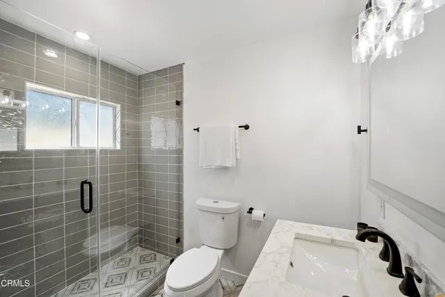 a bathroom with a toilet a sink and shower