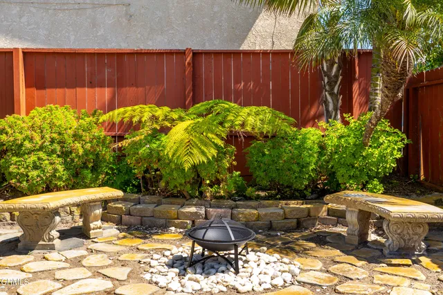 a view of a backyard with plants and a patio