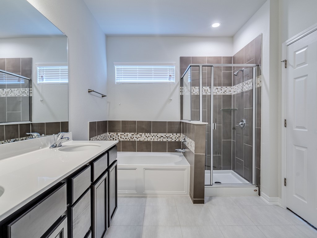 4113 Birdwatch Loop, Unit 21 Pflugerville, TX 78660 - Photo 11 of 30 a bathroom with a tub sink and shower
