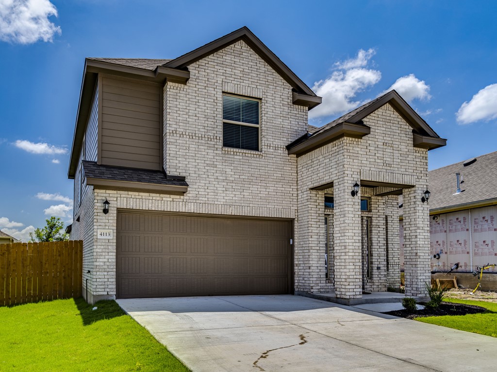 4113 Birdwatch Loop, Unit 21 Pflugerville, TX 78660 - Photo 2 of 30 a front view of a house with garage