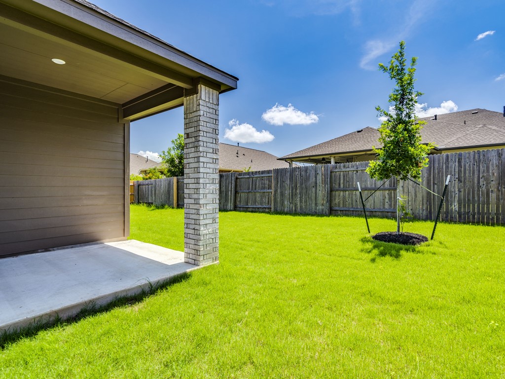 4113 Birdwatch Loop, Unit 21 Pflugerville, TX 78660 - Photo 25 of 30 a view of a backyard with a garden and plants