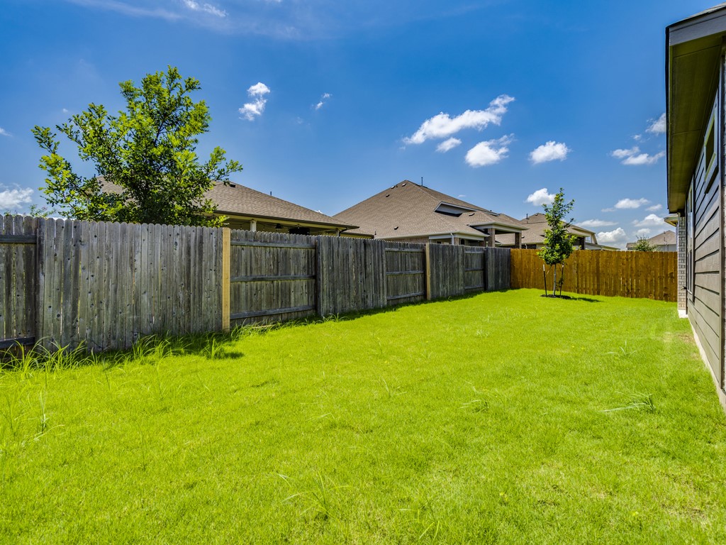 4113 Birdwatch Loop, Unit 21 Pflugerville, TX 78660 - Photo 28 of 30 a view of a house with a backyard
