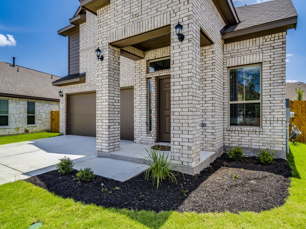4113 Birdwatch Loop, Unit 21 Pflugerville, TX 78660 - Photo 3 of 30 a front view of a house with garden