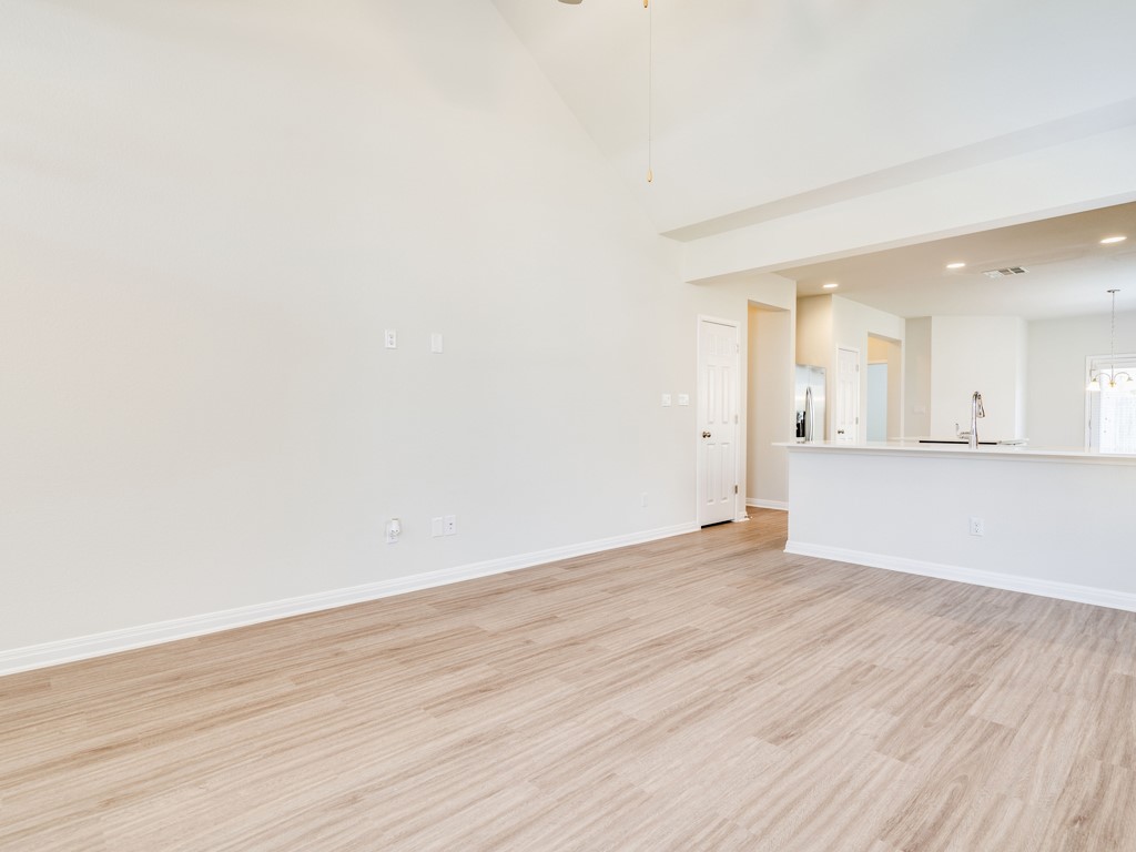 4113 Birdwatch Loop, Unit 21 Pflugerville, TX 78660 - Photo 30 of 30 an empty room with wooden floor and a window