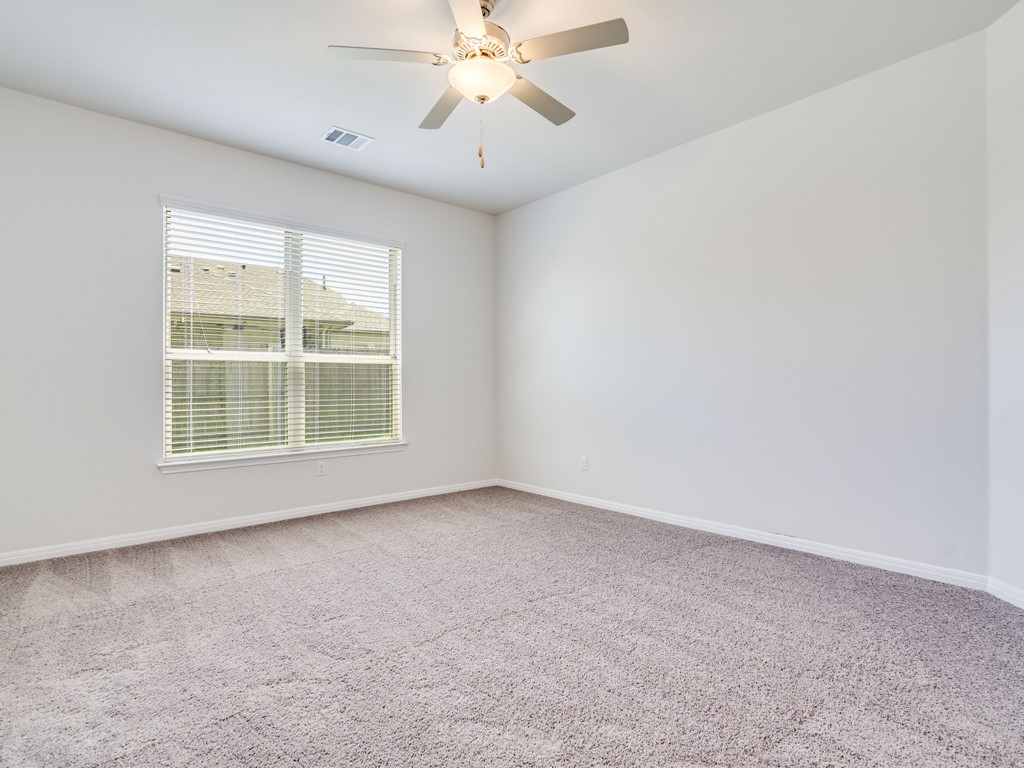 4113 Birdwatch Loop, Unit 21 Pflugerville, TX 78660 - Photo 9 of 30 an empty room with windows and fan