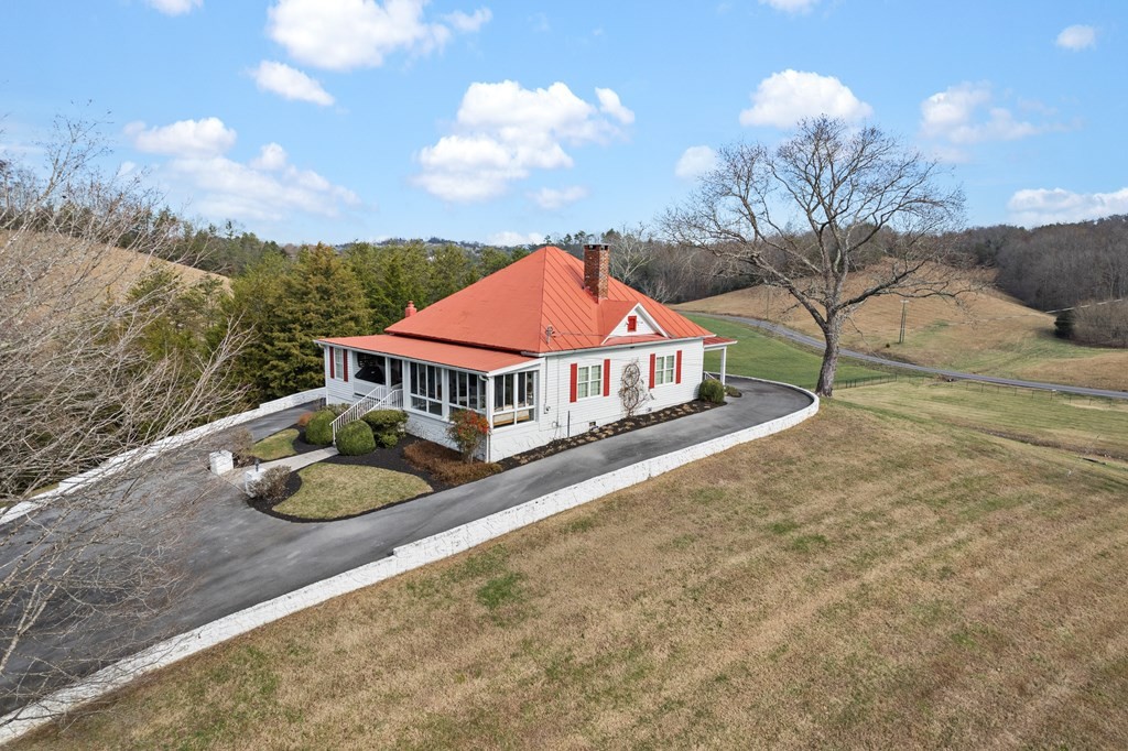 933 Millican Grove Road Sevierville, TN 37876 - Photo 42 of 54 a front view of house with yard & mountain in the background