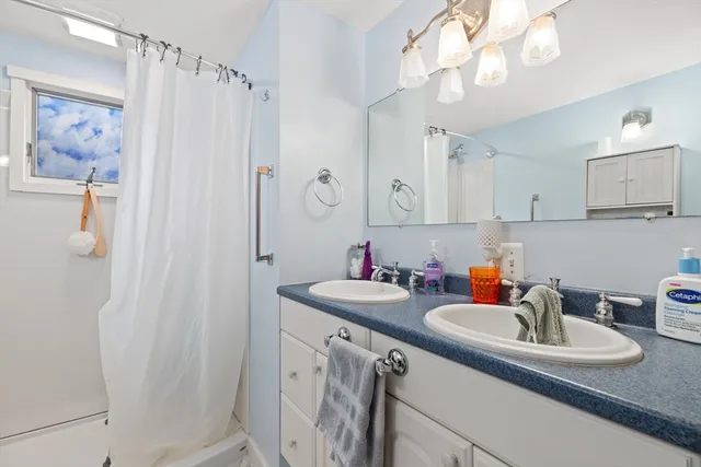 a kitchen with sink a refrigerator and cabinets