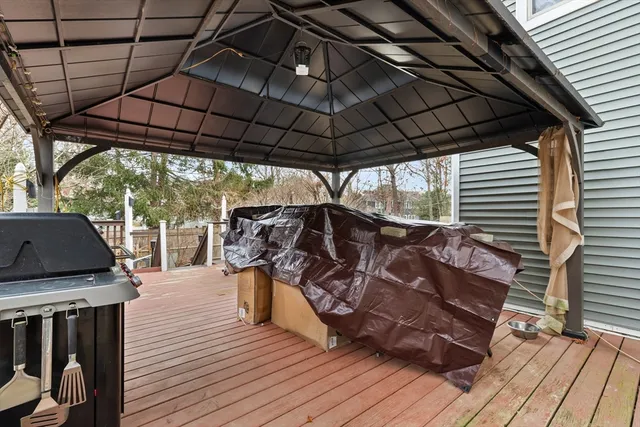 a view of a outdoor space with wooden floor and barbeque oven