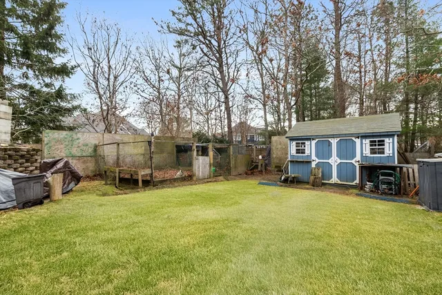 a view of a house with a yard and sitting area