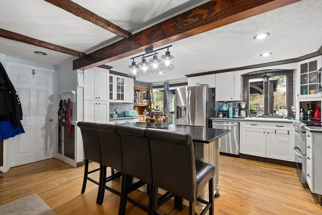 a kitchen with refrigerator and cabinets