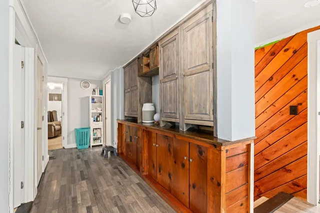 a view of hallway with wooden floor and staircase