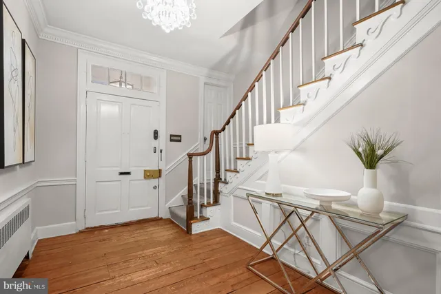 a view of entryway and hall with wooden floor